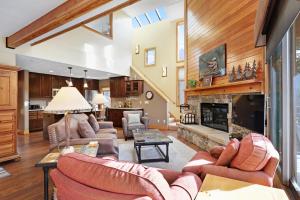 a living room with couches and a fireplace at Montezuma Condominiums in Keystone
