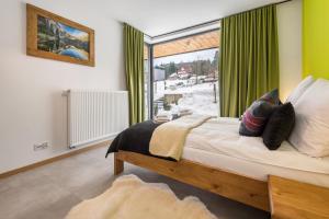 Ένα ή περισσότερα κρεβάτια σε δωμάτιο στο Chłabówka Apartments