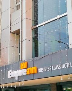 a building with a sign for a business class hotel at EMPIRE INN HOTEL in Chennai