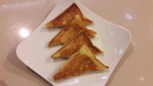 a white plate with four pieces of toast on it at Eureka Villas Siem Reap in Siem Reap