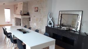 a living room with a white table and a mirror at La Floiracaise in Floirac