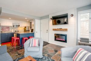 a living room with two chairs and a fireplace at Blue Mountain (1 bedroom) Escape at North Creek Resort in Blue Mountains