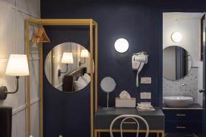 a room with a mirror and a vanity with a camera at The Mellow Pillow Hotel @ Chiang Mai Gate in Chiang Mai +168 photos