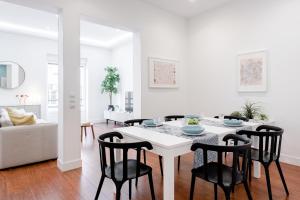 een witte woonkamer met een witte tafel en stoelen bij Luxury Apartment Princesa in Madrid