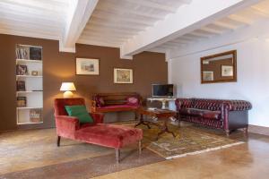 a living room with two chairs and a couch at Palazzo Chigi Zondadari in Siena