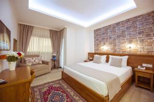 a hotel room with a bed and a couch at Infinity City Hotel in Fethiye