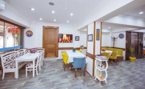 a restaurant with tables and chairs and a fireplace at Infinity City Hotel in Fethiye
