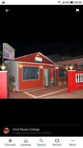 a small red building with avertisement for at Amit Niwas in Mahabaleshwar