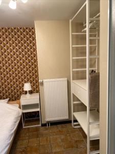 a bedroom with a bed and a white closet at Studio Rue de Pommard in Francorchamps