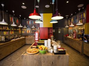 a large kitchen with a table with food on it at ibis Vilnius Centre in Vilnius
