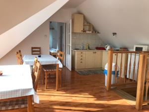 a kitchen and dining room with a table and chairs at Boróka Vendégház in Matrakeresztes