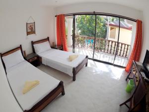 Postel nebo postele na pokoji v ubytování Alona Vida Beach Resort