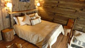 a bedroom with a bed in a wooden room at Tana Della Volpe in Sestriere