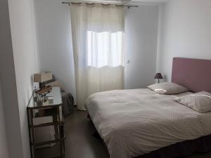 a small bedroom with a bed and a window at Appartements Porto-Piano in Propriano