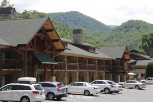 a large building with cars parked in a parking lot at Greystone Lodge on the River in Gatlinburg