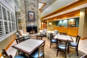 a restaurant with tables and chairs and a fireplace at Greystone Lodge on the River in Gatlinburg
