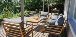 a porch with chairs and a table on a deck at Miiluranta Villas in Haapamäki