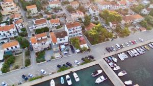an aerial view of a city with boats in a harbor at Gina Bed & Breakfast in Tisno