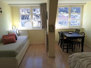 a bedroom with a bed and a table and chairs at Chalet Bruyère in Cauterets