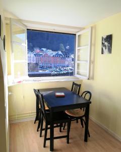 a dining room with a table and chairs and a window at Chalet Bruyère in Cauterets +19 photos