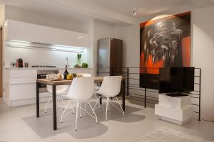 a kitchen with a table and chairs and a television at La Cortevecchia in Bergamo