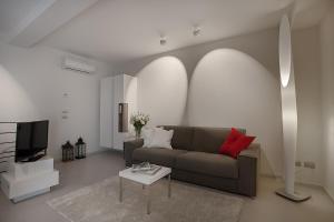 a living room with a couch and a tv at La Cortevecchia in Bergamo