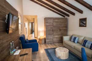 a living room with a couch and a table at Hotel Ambassador Zermatt in Zermatt