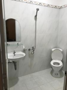 a bathroom with a sink and a toilet and a mirror at MOON Home in Vung Tau