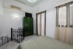 
a small room with a wooden floor and a large window at Anastasia Apartments in Chania
