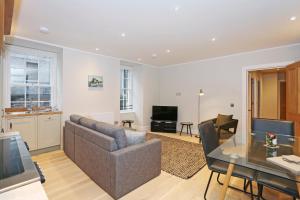 a living room with a couch and a table at ALTIDO Modern and Airy flat on the Historic Royal Mile in Edinburgh