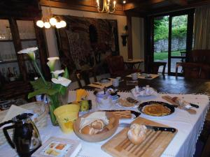 a table with a white table cloth with food on it at Bonavia B&B in Sistiana