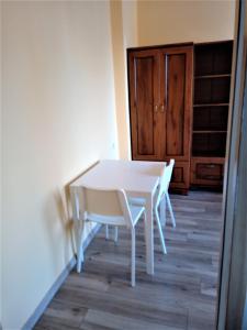 einen weißen Tisch und Stühle in einem Zimmer in der Unterkunft Studio Daola in Danzig