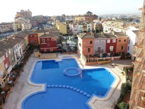an overhead view of a large swimming pool in a city at Apartamento PortSaplaya in Port Saplaya