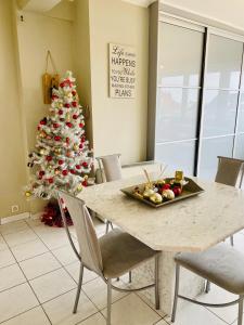 a table with a christmas tree in a room at Casinostraat 16/67 in Blankenberge