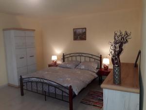 a bedroom with a bed and two lamps and a dresser at Apartmány Matilda in Pribylina +74 photos