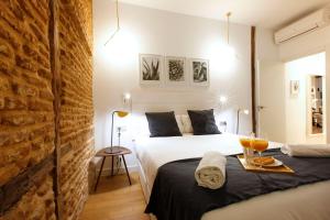 a bedroom with two beds and a table with a tray of food at Madrid Centric II by Madflats Collection in Madrid