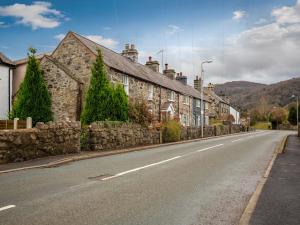 an empty street with a row of stone houses at Conwy Valley Hotel in Conwy