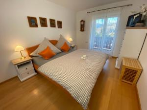 a small bedroom with a bed and a window at FeWo Waldkauz in Berchtesgaden
