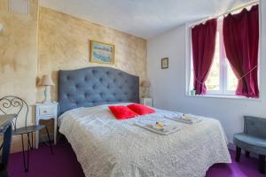 a bedroom with a blue bed with red pillows at B&B Château De La Houssoye in La Houssoye +36 photos
