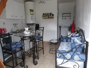 a small kitchen with a table and chairs in a room at Chambres d'Hotes Elvire et Laurent Barbey in Sainte-Marie-du-Mont