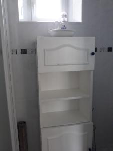 a white bathroom with a sink and a mirror at Chambres d'Hotes Elvire et Laurent Barbey in Sainte-Marie-du-Mont