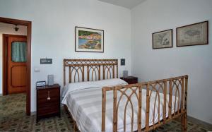 ein Schlafzimmer mit einem Holzbett und zwei Nachttischen in der Unterkunft Il Torrione sul mare G1 in Ischia