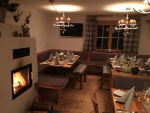 a dining room with a table and a fireplace at Gasthaus Moosegg in Lochau