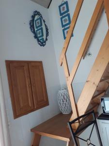 a staircase in a room with a table and a wooden door at Chambres d'Hotes Elvire et Laurent Barbey in Sainte-Marie-du-Mont