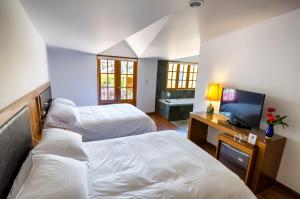 Postel nebo postele na pokoji v ubytování La Hostería Boutique Hotel