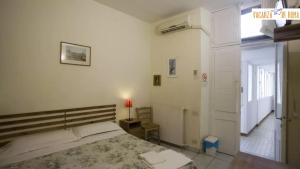 a white bedroom with a bed and a window at Al Pantheon Con Thomas Mann in Rome