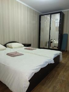 a bedroom with two beds and a large window at Проспект Незалежності 48 City Rooms in Bila Tserkva