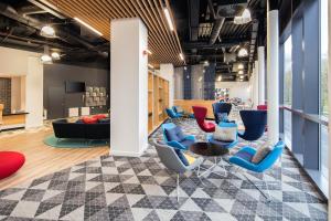 a lobby with blue chairs and a table at Holiday Inn Express - Birmingham - City Centre by IHG in Birmingham