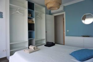 a bedroom with a large white bed with towels on it at CASA LUCA in Estepona