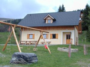 a house with a playground in front of it at Ferienwohnung A 55 m2 in Lachtal